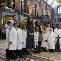 Britain\'s Catherine, Duchess of Cambridge, poseswith pupils from Oakington Manor Primary School, in front of Dippy the Diplodocus, as she attends a children\'s tea party to celebrate Dippy\'s time in Hintze Hall at the Natural History Museum in London Tuesday. | REUTERS