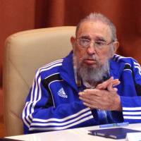 Cuban former President Fidel Castro applauds during the closing ceremony of VII Congress of the Cuban Communist Party in Havana. Castro died Saturday, according to a statement from the President of Cuba, Raul Castro. | AGENCIA CUBANA DE NOTICIAS / VIA AFP-JIJI