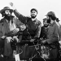 Cuban rebel leader Fidel Castro (center), surrounded by the members of his leftist guerrilla movement, waves from a jeep entering Havana after his victory over the forces of Cuban dictator Fulgencio Batista in January 1959. Castro died late Friday at the age of 90. | AFP-JIJI