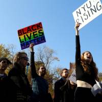 Students of New York University hold signs during a demonstration joining with other colleges across the nation participating in #SanctuaryCampus, a protest targeting President-elect Donald Trump in Manhattan, New York, Wednesday. NYC mayor vows to protect immigrants as collegians across U.S. march against Trump deportation plans