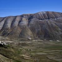 A general view shows the village of Castelluccio and the Monte Vettore on Wednesday, three days after a 6.5-magnitude earthquake hit central Italy. Satellite images found that Sunday\'s temblor deformed the landscape over 130 sq. km (50 sq. miles), the Italian National Research Council said in a statement. The biggest displacement was in the Castelluccio region, near the small town of Norcia, which lay only 6 km (3.7 miles) from the epicenter, it said. The ground in this region was pushed up or sank by up to 70 cm. | AFP-JIJI