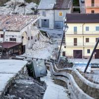A badly damaged road is seen in Castelluccio di Norcia, central Italy, Wednesday. Authorities say more than 100,000 people were affected by the 6.6-magnitude quake on Sunday, either sustaining property damage or being frightened from their homes. | MASSIMO PERCOSSI / ANSA VIA AP