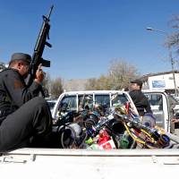 Water pipes are seen at the back of a police vehicle after being seized during a raid confiscating shisha water pipes in Kabul Sunday. | REUTERS