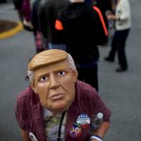 Donald Trump supporters wait in line outside before Melania Trump, wife to the Republican Presidential nominee, holds an event at Main Line Sports in Berwyn, Pennsylvania, Thursday. | REUTERS