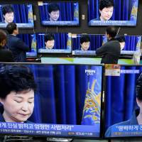 Televisions broadcast a news report on South Korean President Park Geun-hye\'s statement to the public about a scandal that has roiled her administration in Seoul on Friday. | REUTERS