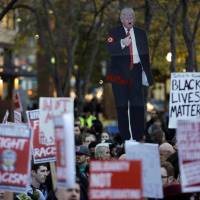 People gather in protest to the election of Republican Donald Trump as U.S. president in Seattle, Washington. | REUTERS