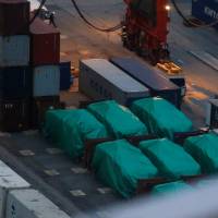 Six of the nine armored troop carriers belonging to Singapore, from a shipment detained at a container terminal, are seen in Hong Kong on Thursday. Singapore armored vehicles seized by Hong Kong customs