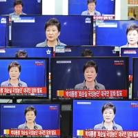TV screens display the live broadcast of South Korean President Park Geun-hye\'s public announcement at an electronic shop in Seoul on Tuesday. | AP
