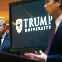 Real estate mogul and reality TV star Donald Trump listens as Michael Sexton introduces him at a 2005 news conference in New York, where he announced the establishment of Trump University. Trump is scheduled to go on trial this month in a class-action lawsuit against him and his now-defunct Trump University, potentially taking the witness stand weeks before his inauguration as president of the United States. | AP