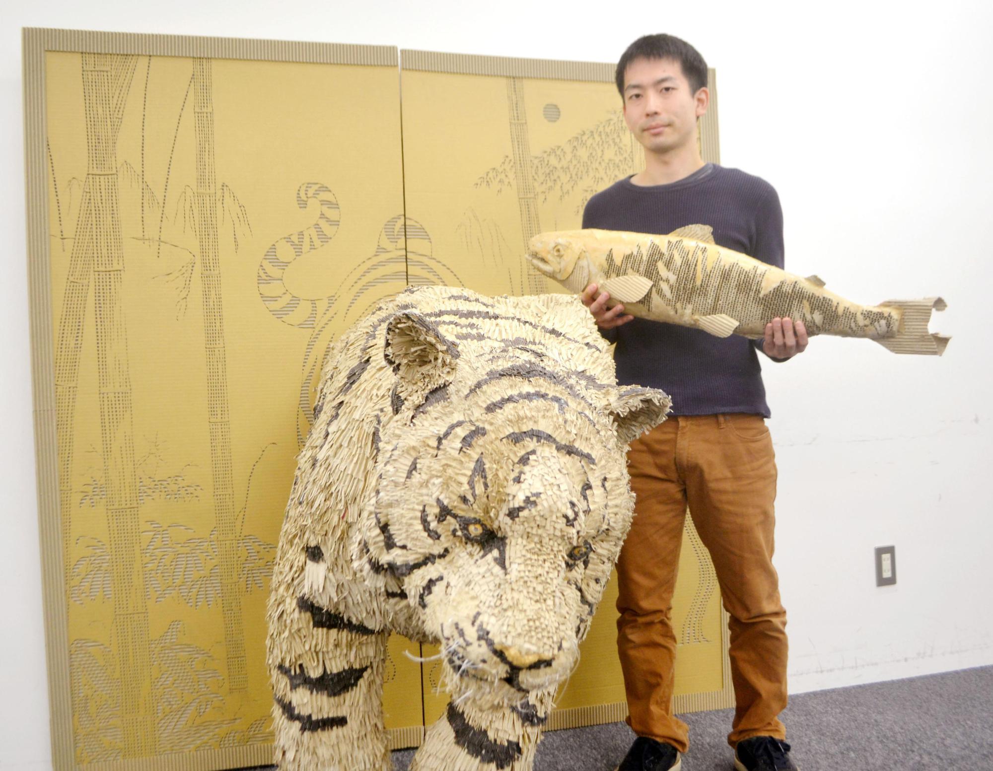 Paper creations: Suguru Yoshida displays a couple of his cardboard animals in Hokkaido in October. | KYODO