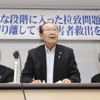 Shigeo Iizuka, center, head of a group representing the families of Japanese abducted by North Korea, speaks at a gathering in Tokyo last month. | KYODO