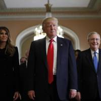 President-elect Donald Trump and his wife, Melania, walk with Senate Majority Leader Mitch McConnell on Capitol Hill in Washington on Thursday. | AP