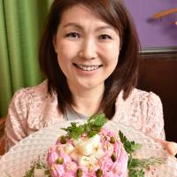 Mitsuki Moriyasu shows off a cake made from vegetables and tofu in this undated photo in Nagoya. Nagoya restaurant's guiltless, gluten-free cake finds fans overseas