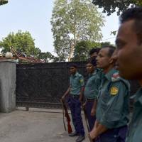 Bangladeshi police stand guard Tuesday in front of the entrance to the Holey Artisan Bakery in Dhaka, where Islamist extremists killed 22 hostages, mostly foreigners. Police have handed the Holey Artisan Bakery back to its owners after completing a four-month investigation into the siege by extremists linked to the Islamic State group. The owner of the Bangladeshi restaurant said he would turn the building into a home for his family and reopen the eatery elsewhere. | AFP-JIJI