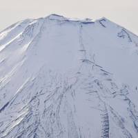 Mount Fuji is capped with ice and snow Sunday. | KYODO