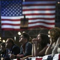 Supporters of Democratic presidential nominee Hillary Clinton watch and wait at her election night rally in New York on Nov. 8. | REUTERS