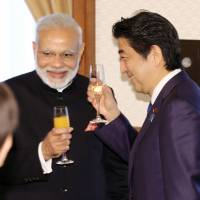 Visiting Indian Prime Minister Narendra Modi and Prime Minister Shinzo Abe make a toast during a luncheon Saturday in Kobe. Modi visited the city to inspect a plant assembling shinkansen bullet trains. | KYODO
