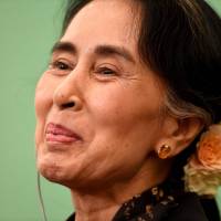 Myanmar State Counselor and Foreign Minister Aung San Suu Kyi smiles at a press conference at the Japan National Press Club in Tokyo on Friday. | AFP-JIJI