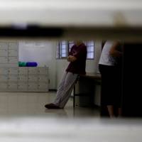 Detainees are seen through a hatch at the Tokyo detention center, part of the Tokyo Regional Immigration Bureau, in December 2015. Solitary confinement not silencing Nigerian asylum activist, or her advocates
