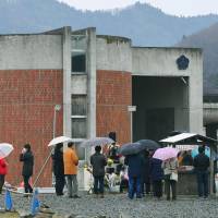 People visit Okawa Elementary School in the city of Ishinomaki, Miyagi Prefecture, last March. A huge tsunami that occurred on March 11, 2011, hit the school, claiming 74 lives. | KYODO