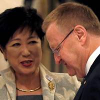 International Olympic Committee Vice President John Coates speaks with Tokyo Gov. Yuriko Koike following the Four-Party Working Group meeting in Tokyo on Tuesday. | REUTERS