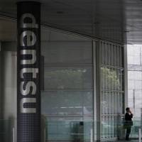 A survey shows just over half of Japanese firms are reviewing rules governing working hours. | REUTERS