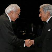 Singapore President Tony Tan shakes hands with Emperor Akihito upon his arrival for a state dinner at the Imperial Palace in Tokyo on Wednesday. | AP