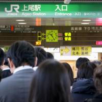 People line up at JR Ageo Station in Saitama Prefecture on Friday morning after a damaged cable halted all train operations on the JR Takasaki Line. | KYODO