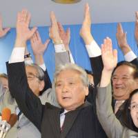 Tochigi Gov. Tomikazu Fukuda celebrates his re-election Sunday evening in Utsunomiya. | KYODO