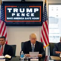 Then-Republican U.S. presidential candidate Donald Trump participates in a roundtable discussion on national security with retired army Gen. Michael Flynn (left) and retired army Lt. Gen. Keith Kellogg in New York in August. | AP