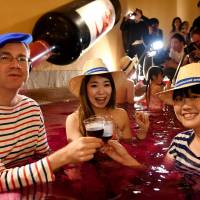 Sweet stains: Bathers toast in a heated pool of Beaujolais. | TOSHIFUMI KITAMURA / AFP-JIJI