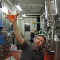 Liquid gold: Jason Koehler, founding partner of DevilCraft Craft Beer & Pizza, inspects a sample of a new brew. A journey to the center of Tokyo's crowded craft beer scene