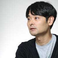 In the director\'s chair: Seiji Nozoe says he doesn\'t really care about the acting abilities of his cast of 1,600 seniors, he\'s more interested in letting them express their 60-plus years of life history on stage. | © MAIKO MIYAGAWA