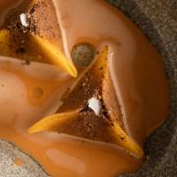 Stylish seafood: Langoustine and squash dim sum dumpings are bathed in a creamy seafood bisque at Hertog Jan. | AP