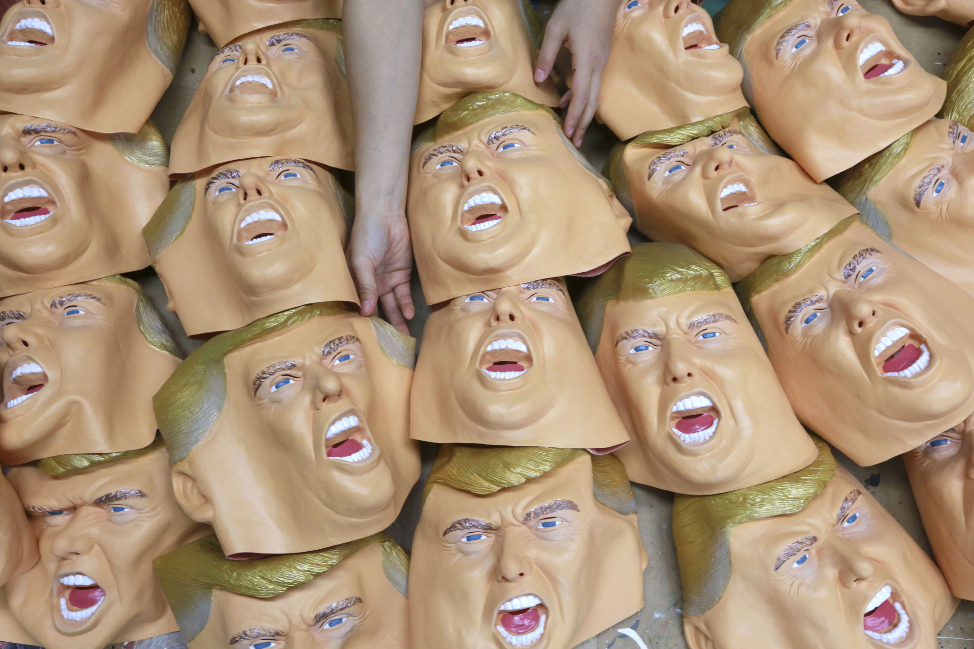 Mug shot: Rubber masks depicting U.S. President-elect Donald Trump await finishing touches at the Ogawa Studio in Saitama on Tuesday. Ogawa Studio is working nonstop to catch up with a flood of orders for Trump masks since his election victory. | AP