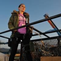 Angela Ortiz is pictured in April 2011 while on an emergency supplies delivery run to tsunami-hit Minamisanriku in Miyagi Prefecture. | COURTESY OF ANGELA ORTIZ