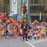 Women, men and children from Aomori in traditional \"haneto\" costumes, a giant \"nebuta\" float made of \"washi\" (Japanese paper) and wire, perform in the Tohoku Rokkon Festival Parade, a giant showcase of northern Japan\'s major festivals.  | MARK THOMPSON