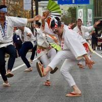 Dancers bearing fans perform the Sendai Suzume Odori. The lively folk dance traces its origins back to the sparrow-like movements of stonemasons celebrating completion of the Aoba Castle in 1637. | MARK THOMPSON