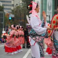 Performers of the Yamagata Hanagasa share a moment. | MARK THOMPSON