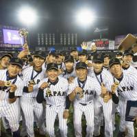 The Japanese team poses for a photo after defeating Australia in the Under=23 Baseball World Cup final on Sunday in Monterrey, Mexico. | KYODO