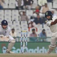 India’s Cheteshwar Pujara plays a cover drive for a boundary as England’s wicket-keeper Jonny Bairstow watches on the fourth day of their third test match in Mohali, India, on Tuesday. India routs England after Root, Hameed defiance