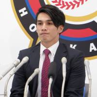 Daikan Yoh of the Hokkaido Nippon Ham Fighters speaks at a news conference on Monday. | KYODO