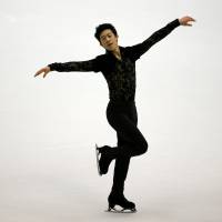 Nathan Chen competes in the men\'s short program on Friday in Sapporo. He earned 87.94 points to take second place. | REUTERS