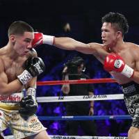 Hiroshige Osawa throws a punch at Mexico\'s Oscar Valdez during their WBO featherweight title fight in Las Vegas on Saturday. | AP