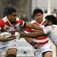 Japan flanker Malgene Ilaua (left) tries to get away from Fiji\'s Metuisela Talebula during their match on Saturday in Vannes, France. | AFP-JIJI