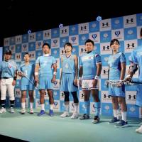 University of Tsukuba athletes pose for photos in their new uniforms during a news conference on Tuesday. | KAZ NAGATSUKA