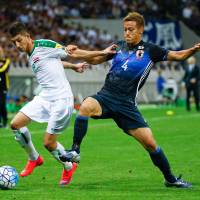 Keisuke Honda (right) tackles Iraq\'s Dhurgham Ismael during Japan\'s 2-1 win in last month\'s World Cup qualifier at Saitama Stadium. | REUTERS