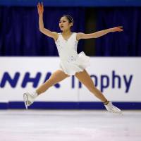 Satoko Miyahara soars through the air during her free program at the NHK Trophy on Saturday. Miyahara finished in second place with 198.00 points. | REUTERS