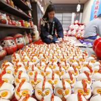 Craftworkers make rooster figurines in Kanagawa Prefecture Wednesday. According to the Chinese zodiac calendar, 2017 is The Year of the Rooster. | KYODO