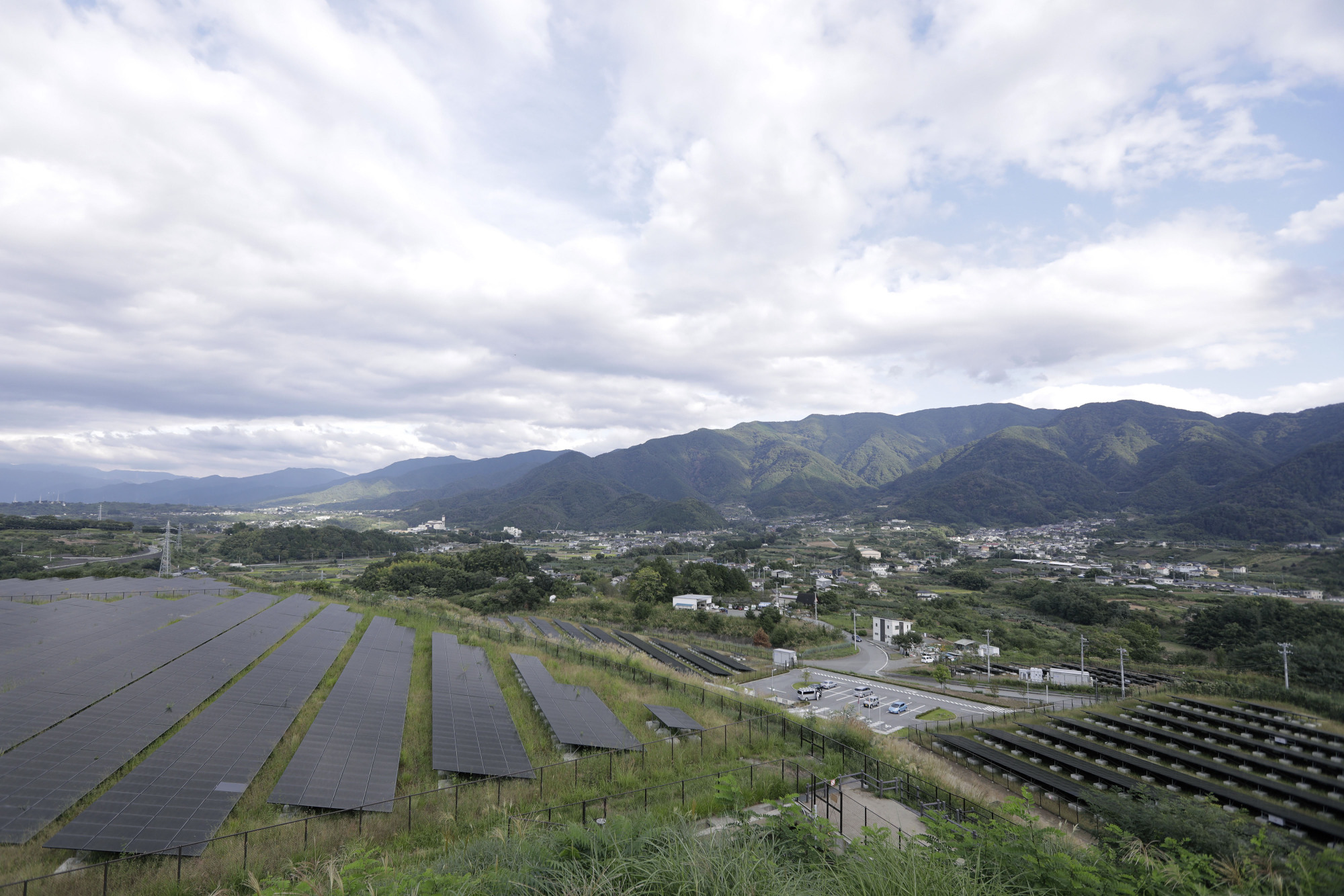 Rows of solar panels are seen in position at the Komekurayama solar power plant in Yamanashi Prefecture. | BLOOMBERG